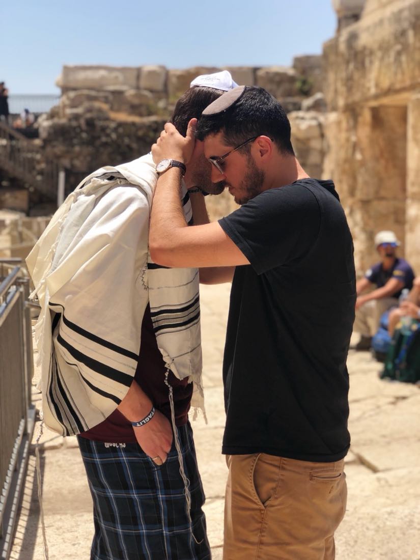 Daniel Reichenbach placing his hands on a Birthright participant’s head in blessing at the Southern Excavations egalitarian prayer area near the Western Wall