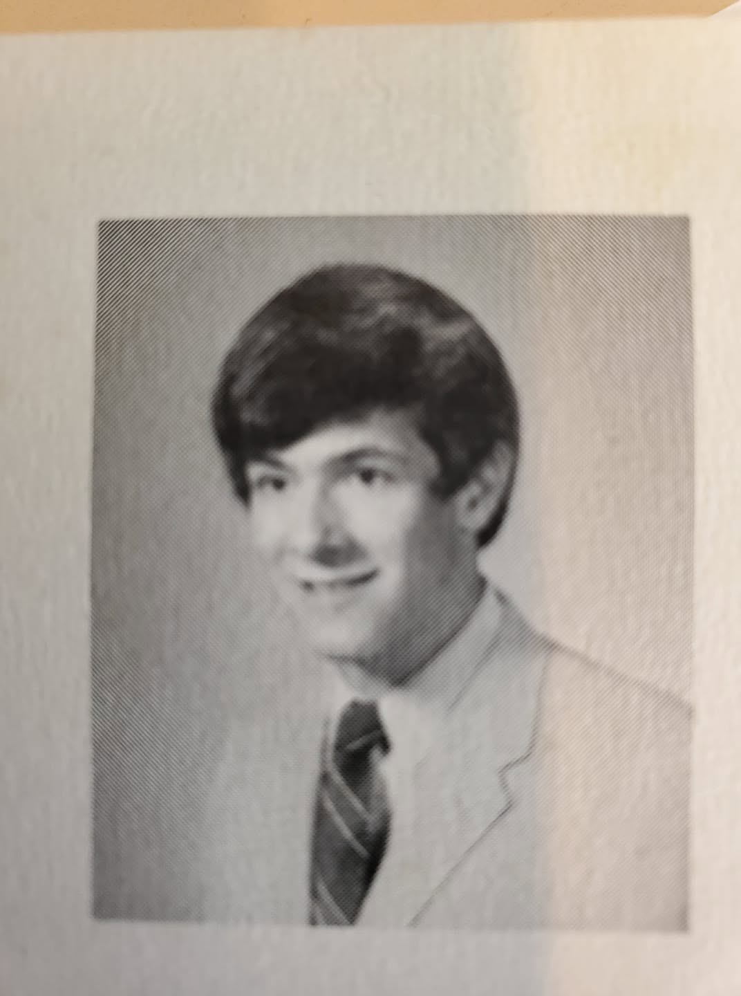 Black-and-white yearbook portrait of a young Paul J. Reichenbach in a jacket and striped tie