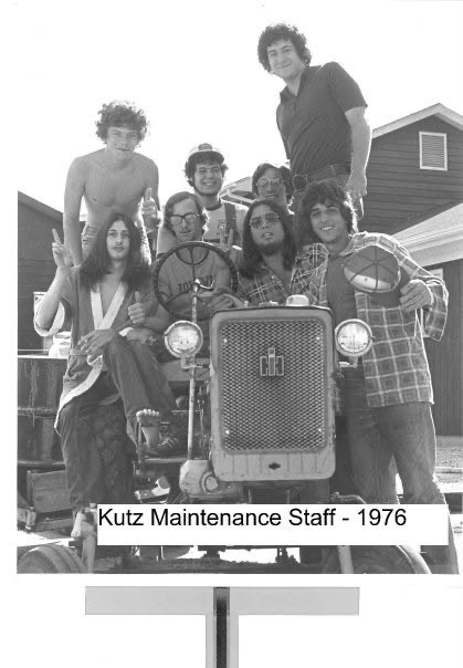 Paul J. Reichenbach and members of the Kutz Camp maintenance staff gathered on and around a tractor in 1976