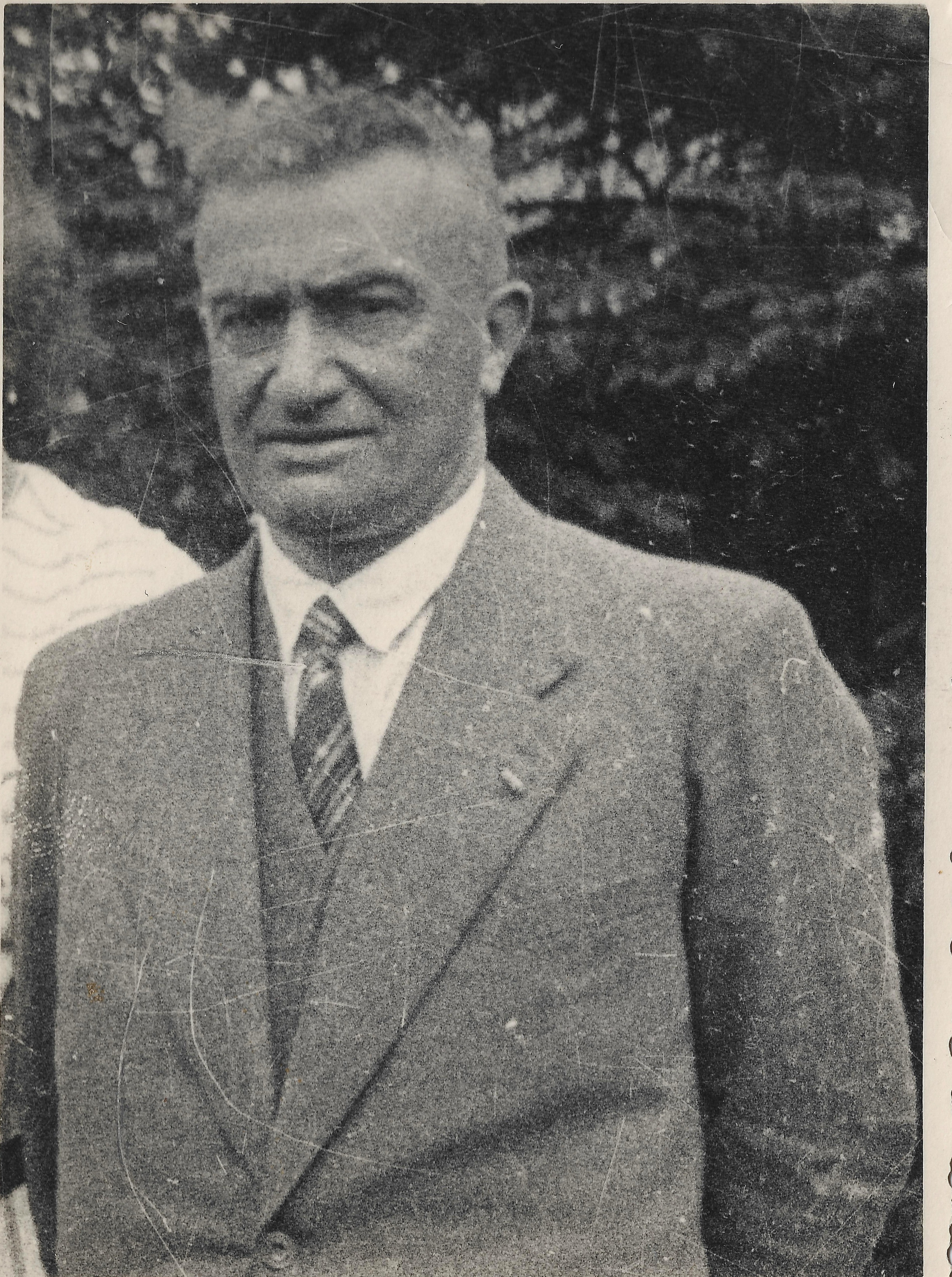 Paul Reichenbach standing outdoors in a suit and tie