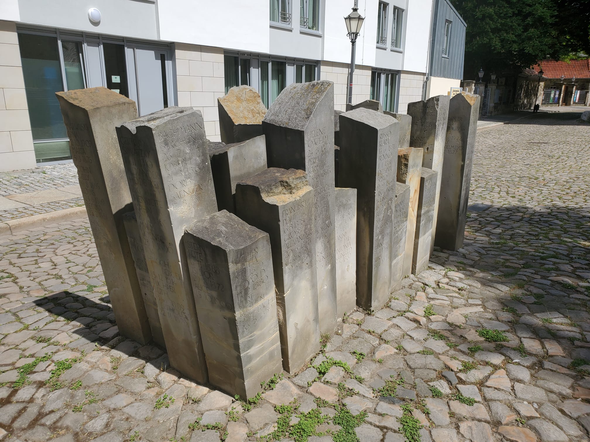 Rows of tall memorial stelae on Halberstadt’s Domplatz, each bearing names and dates